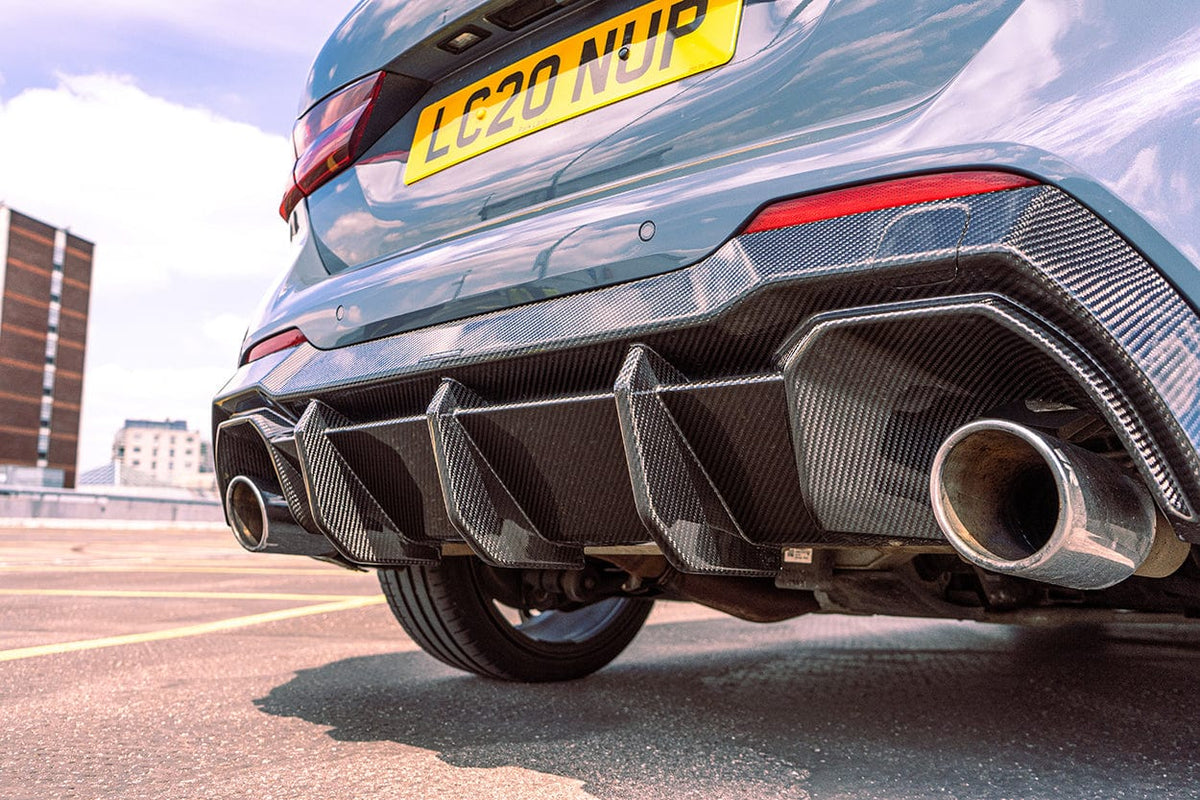 BMW 1 Series F40 carbon fiber diffuser by CT Design, showcasing sleek, aerodynamic rear car enhancement with detailed carbon fiber texture.