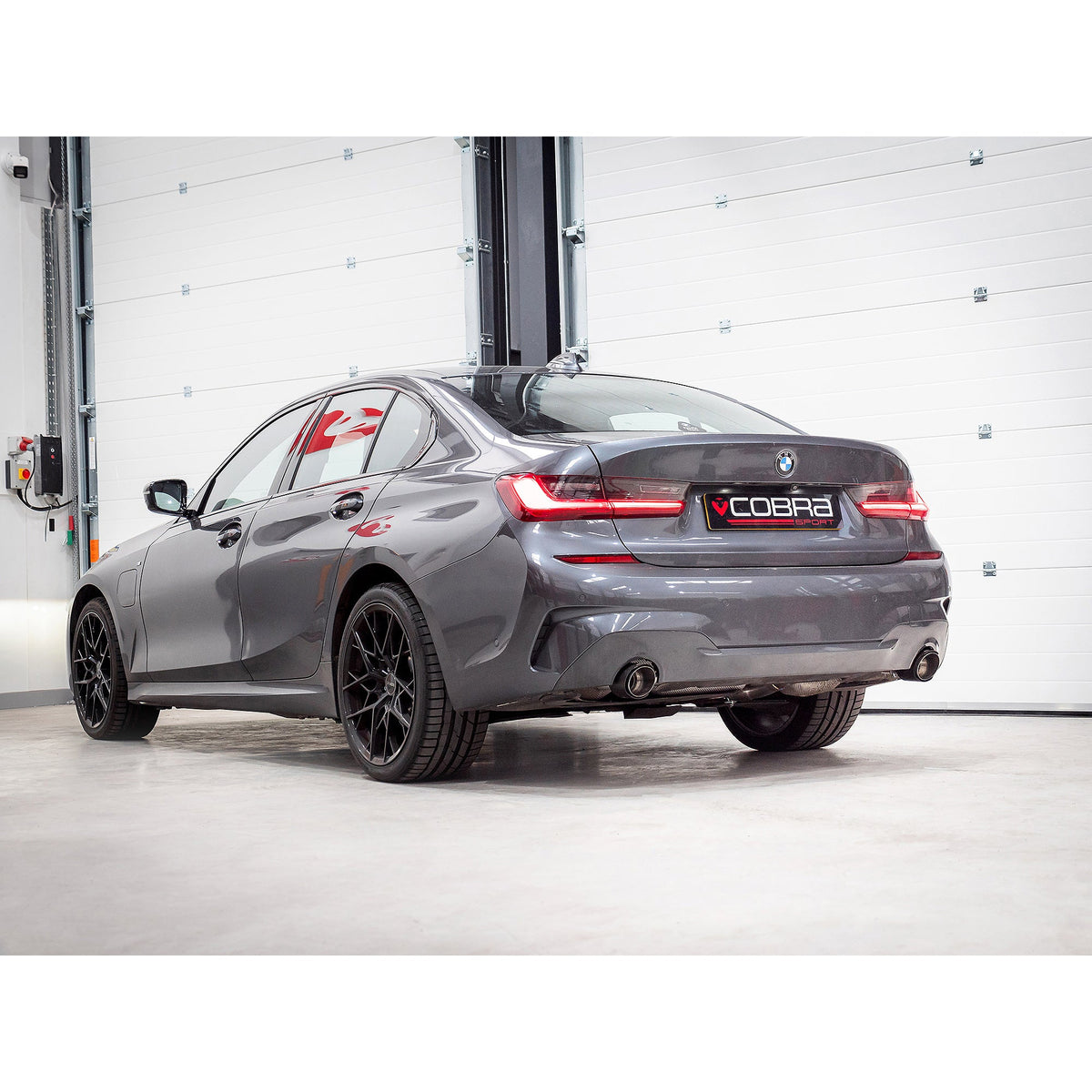 BMW 330e G20 Cobra Sport valved dual exit rear axle back performance exhaust installed on vehicle.