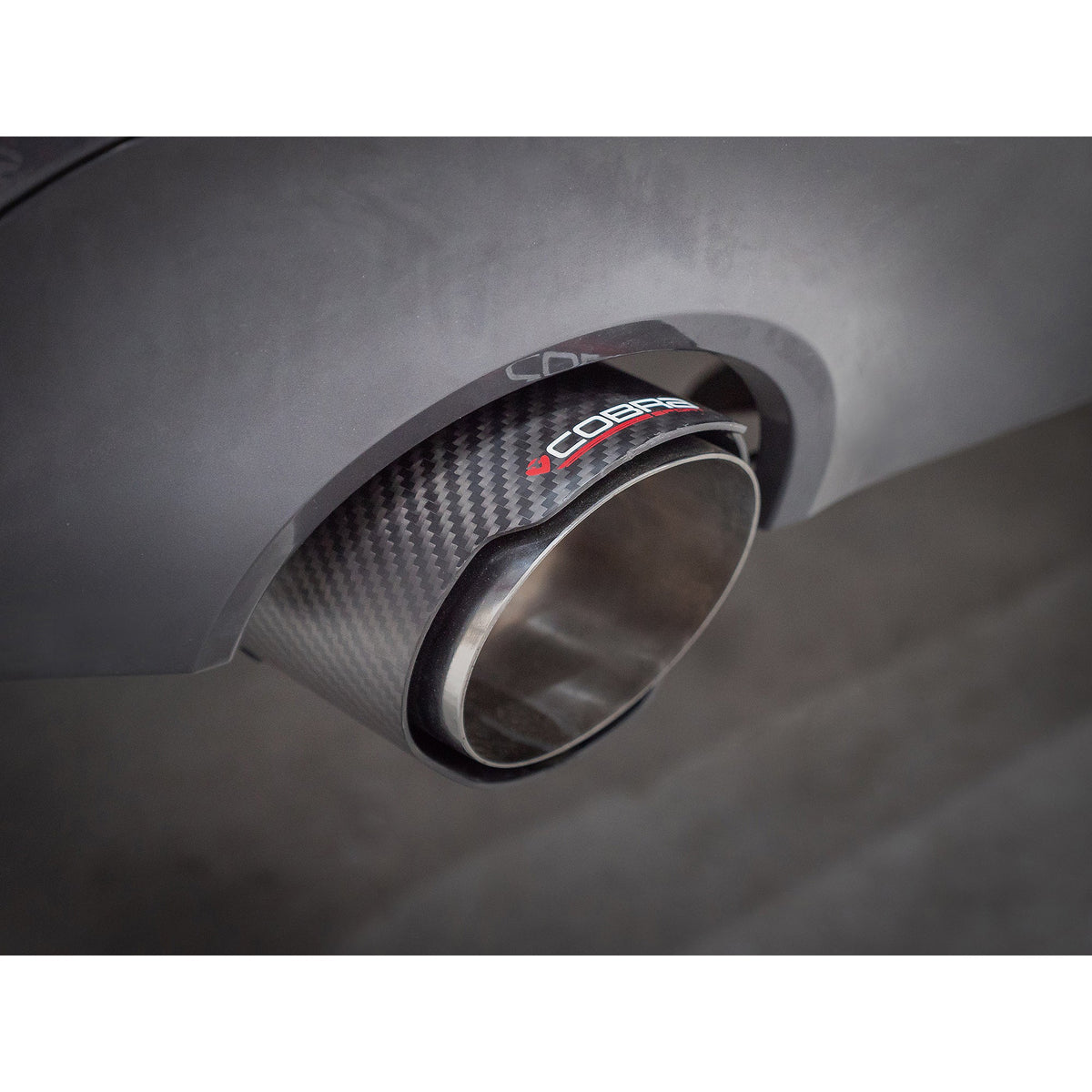 BMW 330e G20 Cobra Sport valved dual exit rear axle back performance exhaust installed on vehicle, showcasing sporty design.
