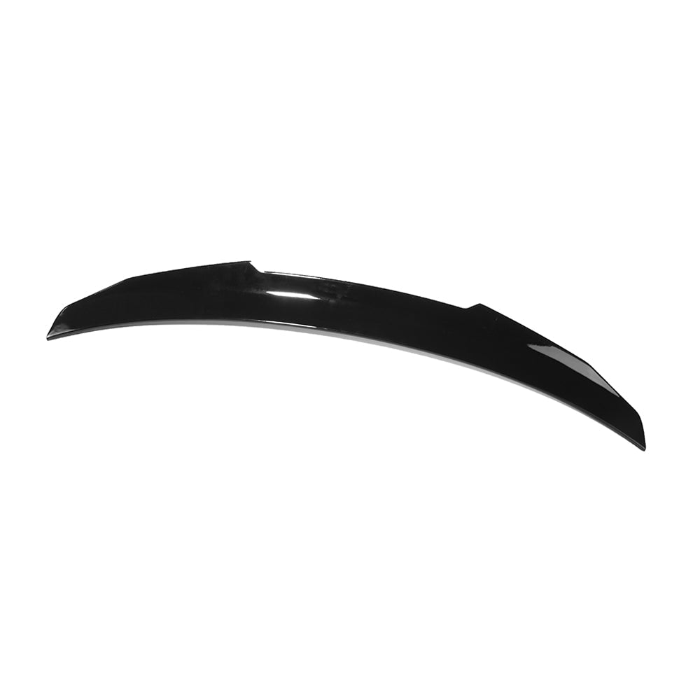BMW 4 Series G22 gloss black V2 spoiler by CT Carbon, showcasing sleek aerodynamic design on the car's rear edge.