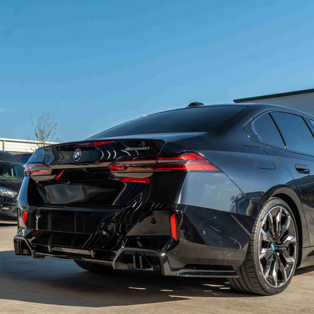 BMW 5 Series G60 and i5 2023 CT Carbon gloss black diffuser showing sleek aerodynamic design and carbon fiber finish.