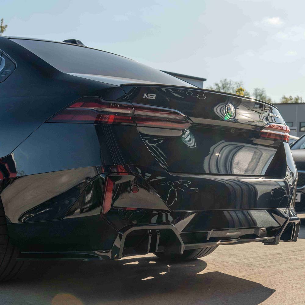 BMW 5 Series G60 and i5 2023 CT Carbon gloss black diffuser showing sleek aerodynamic design for vehicle rear.