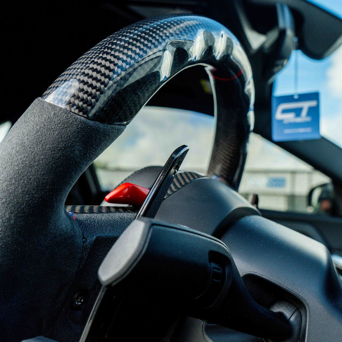 BMW carbon fiber magnetic shifter paddles by CT Carbon shown in close-up, highlighting sleek, lightweight design for car accessories.