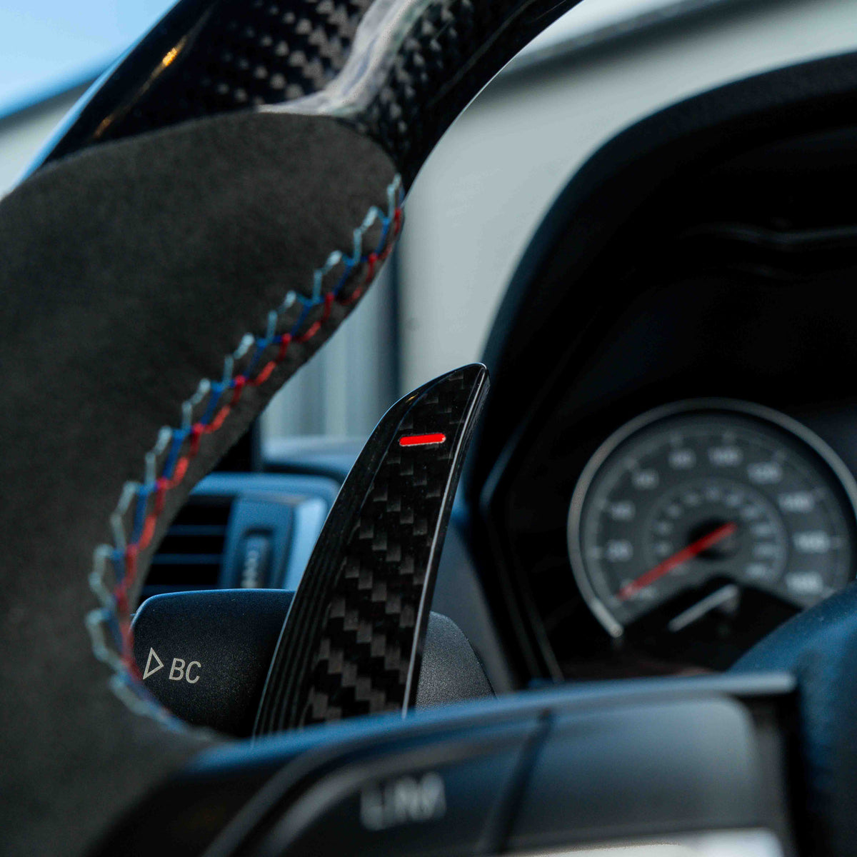BMW carbon fiber magnetic shifter paddles from CT Carbon, showing sleek black carbon fiber design for sporty interior upgrade.