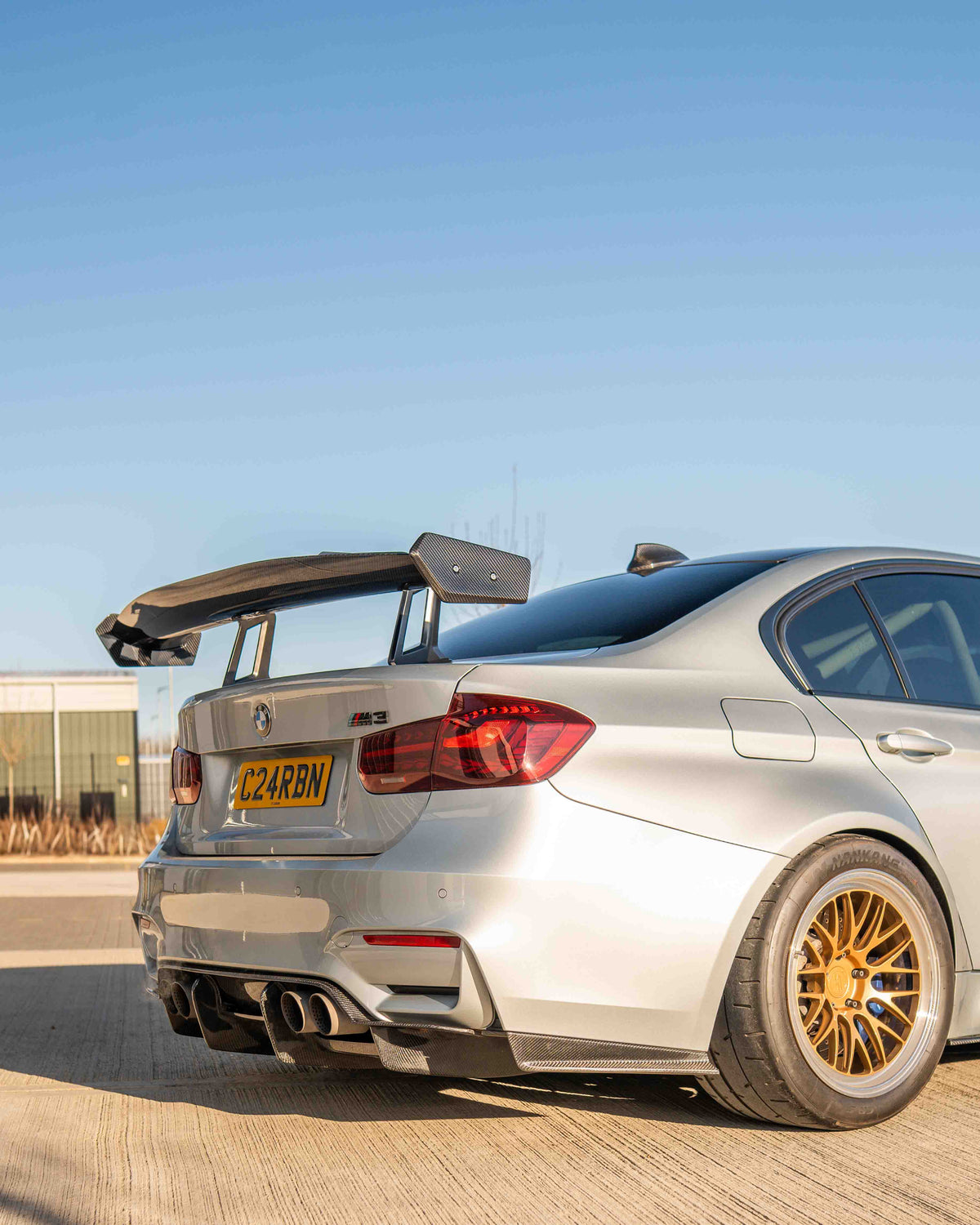 BMW F80 M3 and F30 3 Series carbon fiber swan neck wing spoiler by CT Carbon, showcasing sleek aerodynamic design.
