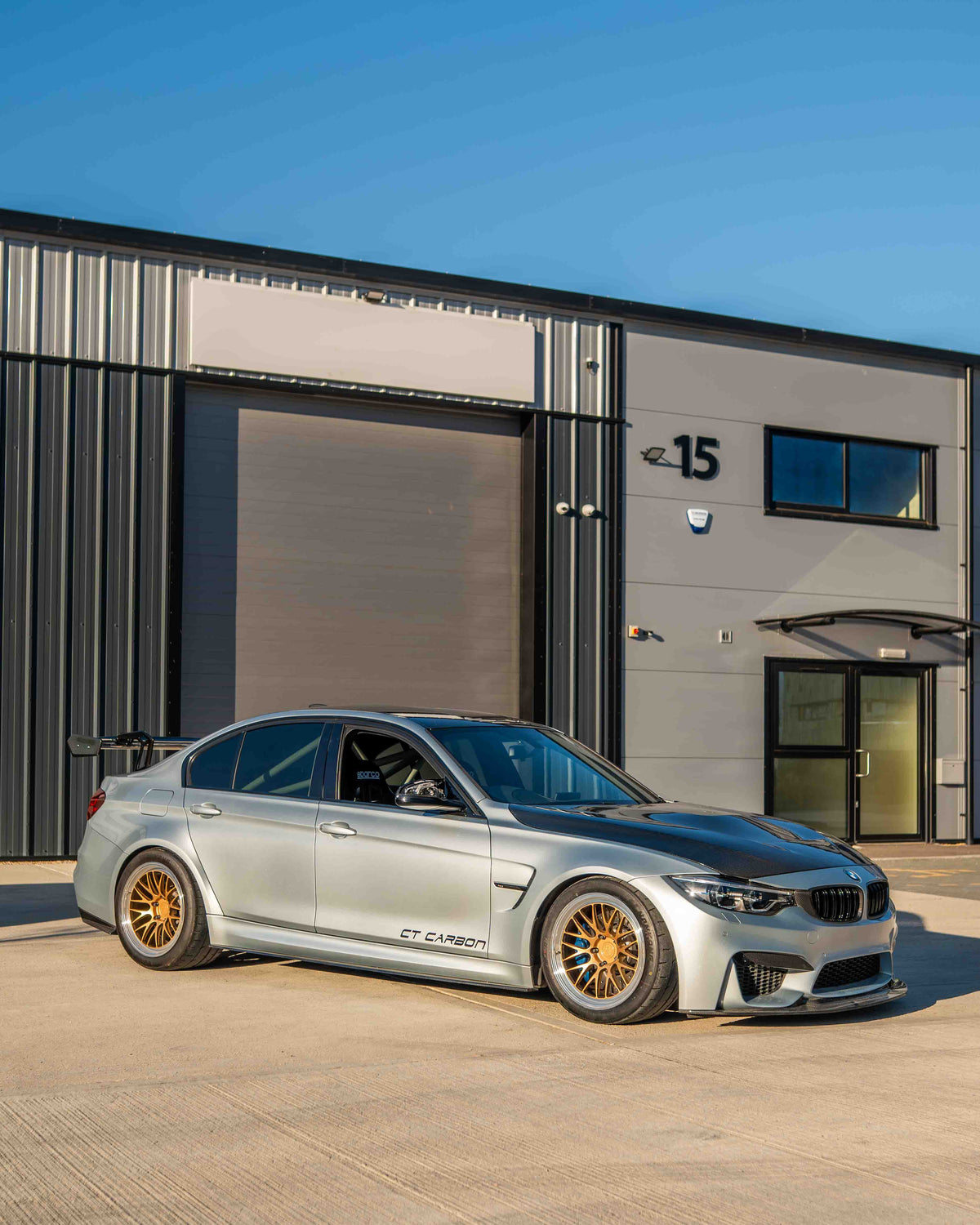 BMW F80 M3 and F30 3 Series carbon fiber swan neck wing spoiler by CT Carbon, showcasing sleek aerodynamic design.