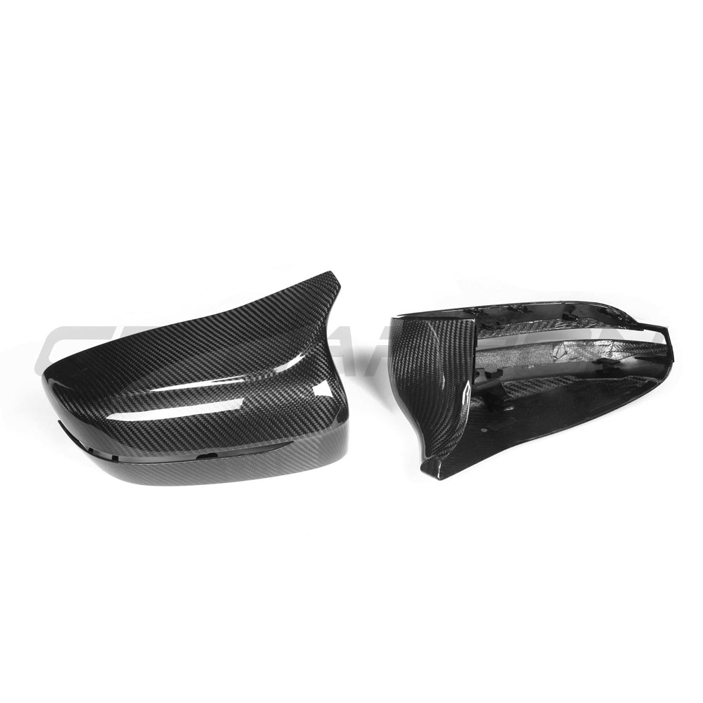BMW F90 M5 2018-2023 pre-preg carbon fiber side mirrors by CT Carbon, LHD model, close-up of sleek, glossy mirror surfaces.