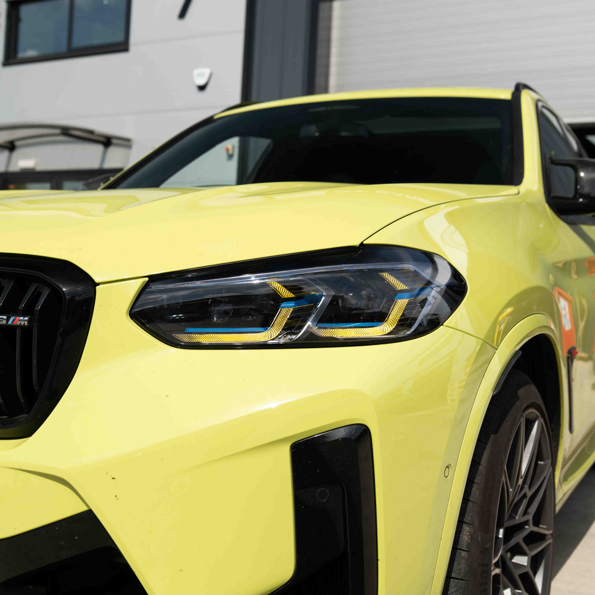 BMW F97 X3M LCI yellow adaptive DRL module set by CT Carbon, showing close-up of the sleek LED daytime running lights.