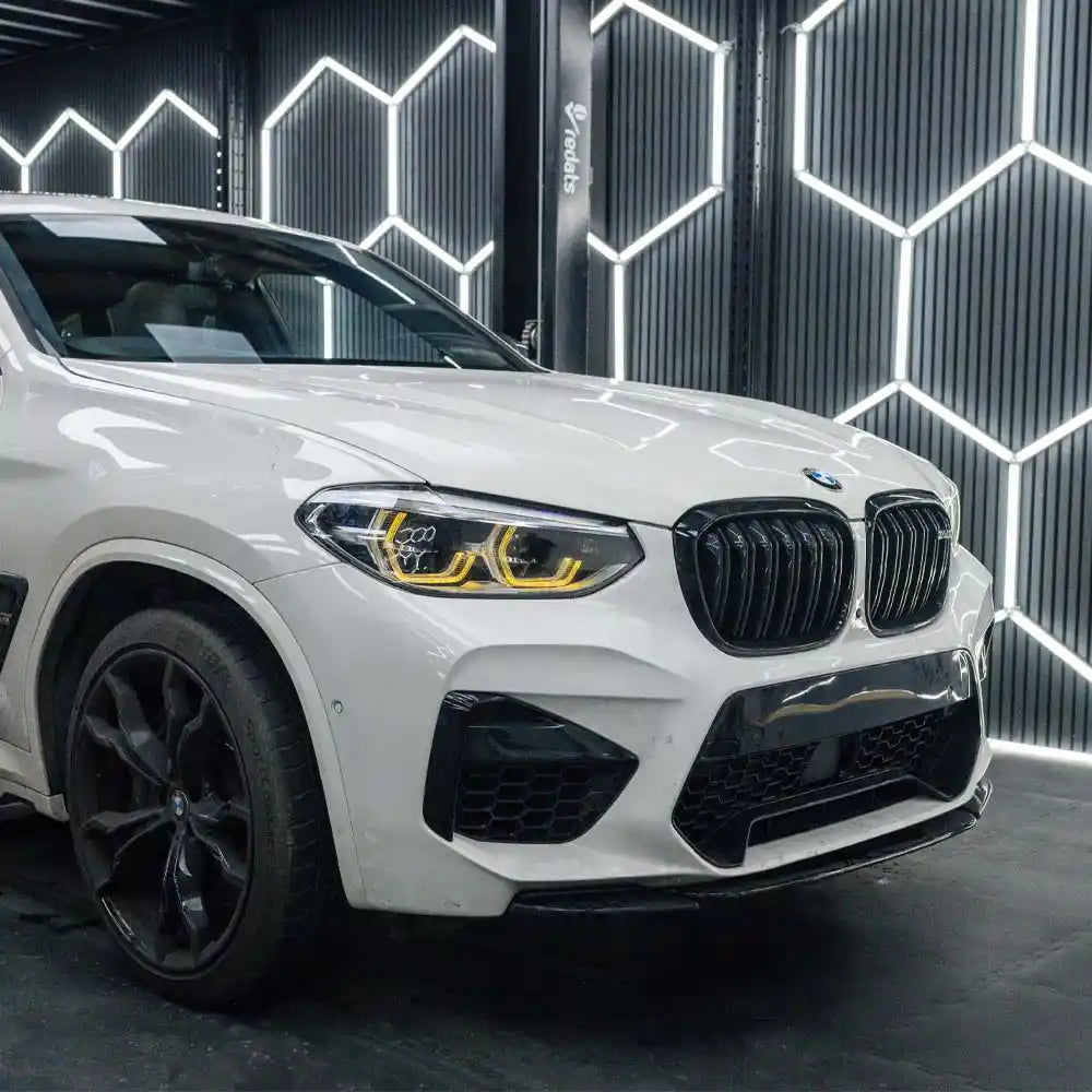 BMW F98 X4M pre-LCI yellow adaptive DRL module set by CT Carbon, showing the sleek yellow daytime running light components for 2018-2021.