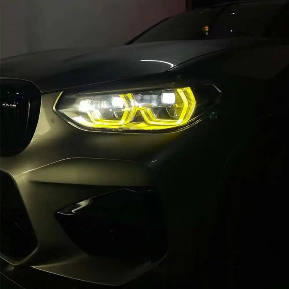 BMW F98 X4M pre-LCI yellow adaptive DRL module set by CT Carbon, showing the LED daytime running lights for model years 2018-2021.
