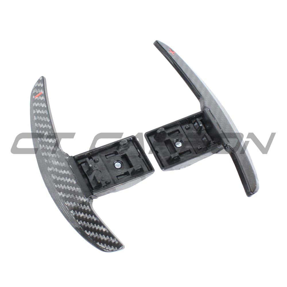 BMW Fxx carbon fiber shifter paddles by CT Carbon, close-up of sleek, lightweight racing-style accessories mounted on steering wheel