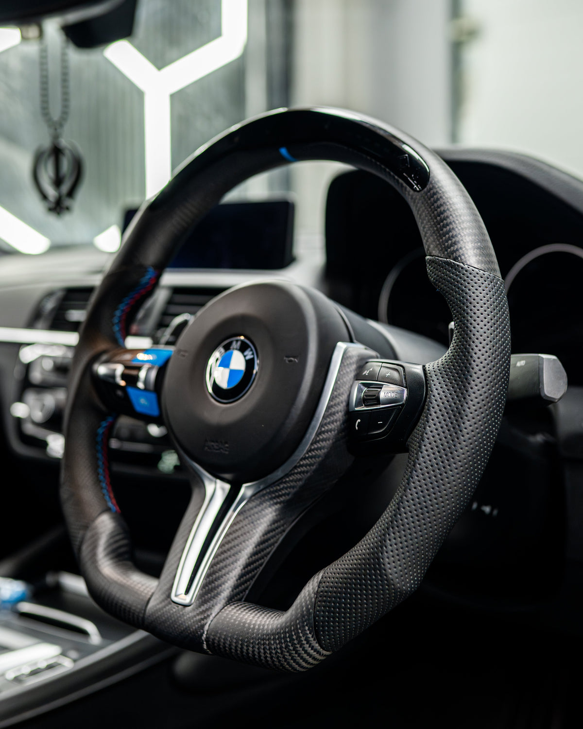 BMW Fxx M carbon fiber steering wheel trim accessory by CT Carbon, with a matte finish and detailed close-up of the trim.