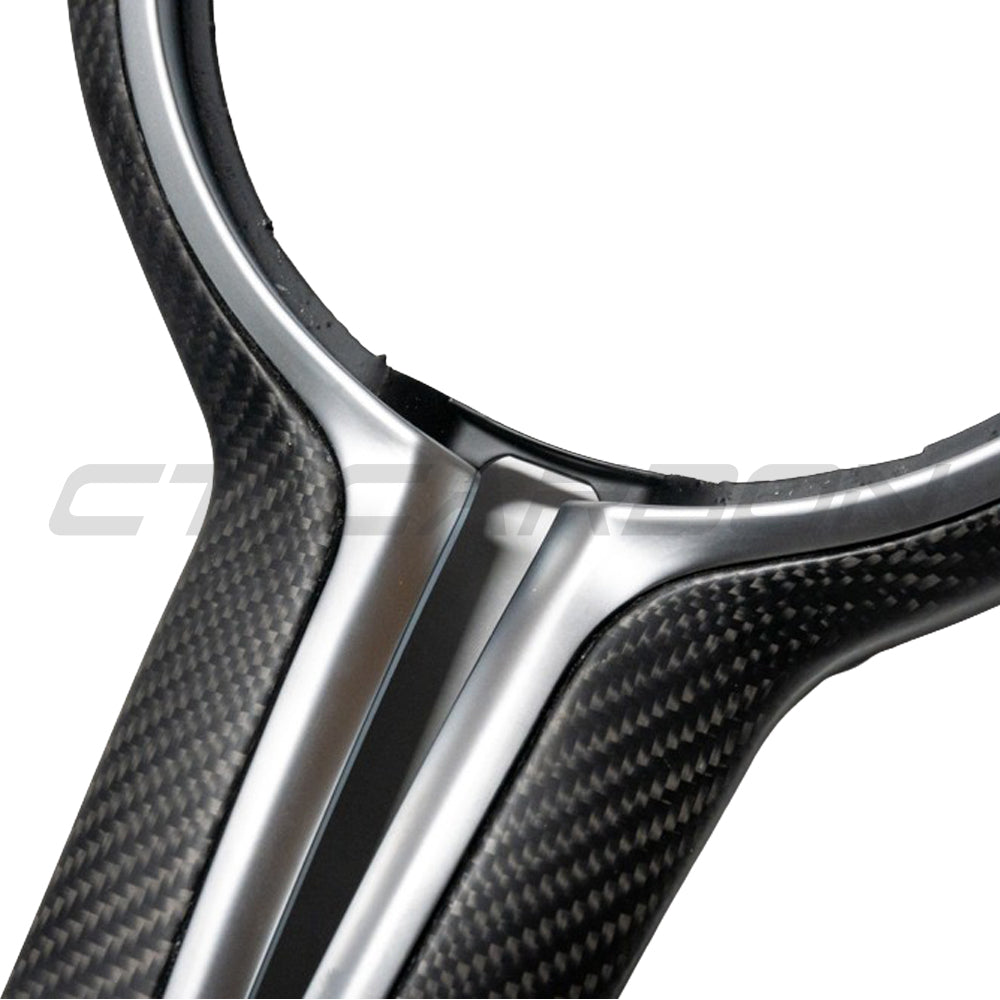 BMW Fxx M series carbon fiber matte steering wheel trim accessory by CT Carbon, showcased on a vehicle's steering wheel.