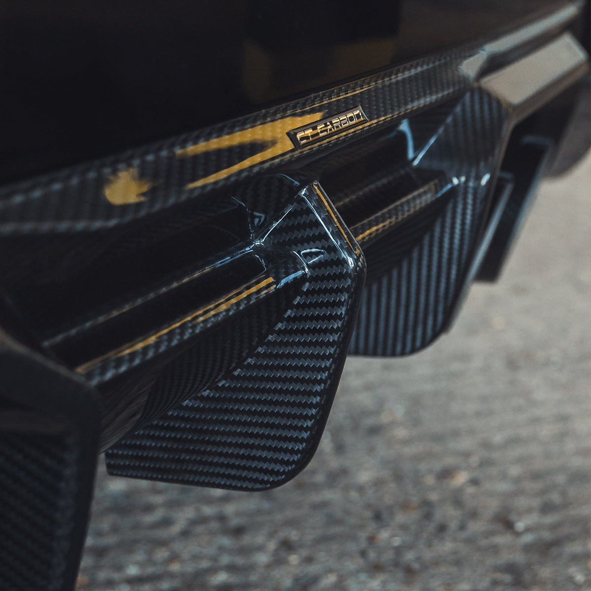BMW G87 M2 carbon fiber diffuser by CT Design, showcasing a sleek, aerodynamic rear diffuser with a textured carbon fiber finish.