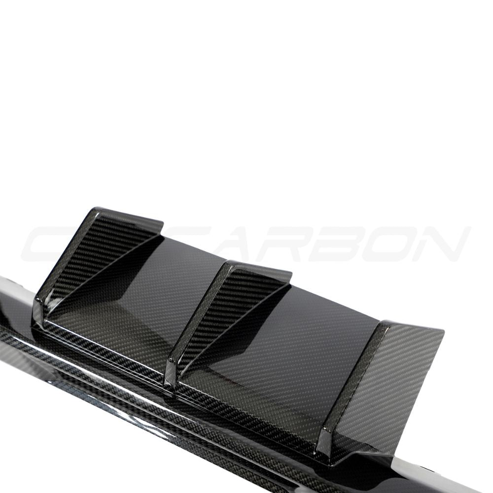 BMW G87 M2 carbon fiber diffuser V3 by CT Design, shown installed on the rear of the sport coupe with detailed carbon fiber texture.