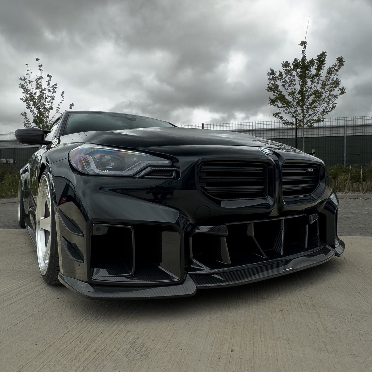 BMW G87 M2 carbon fiber lower grille accessory by CT Carbon, showcasing sleek black carbon fiber with detailed design.
