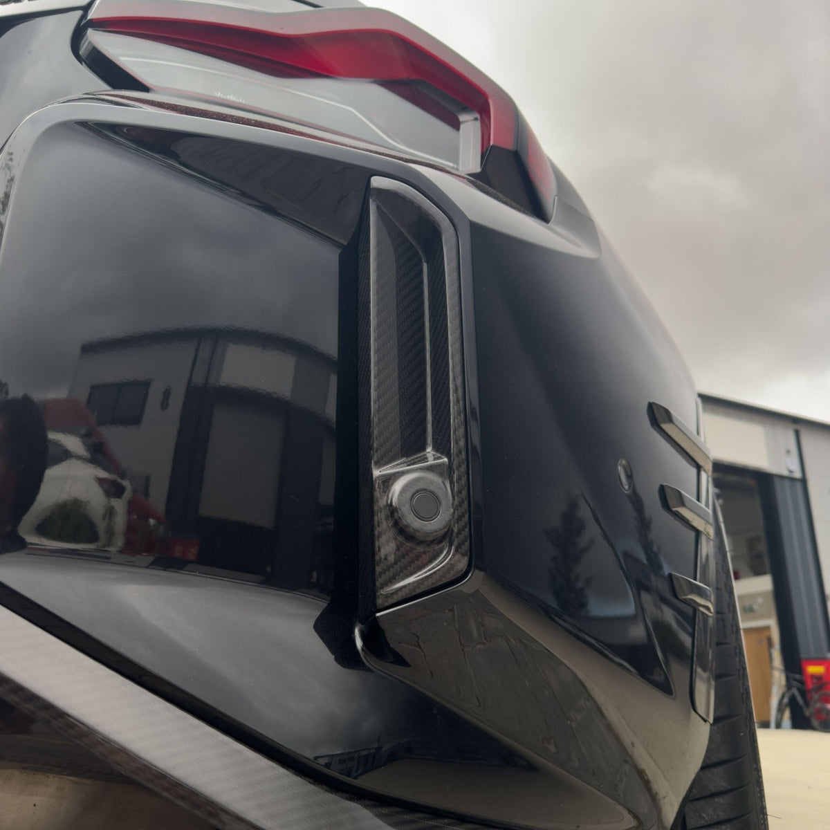 BMW G87 M2 carbon fibre reflector delete accessory by CT Design, shown on the car's rear with sleek black finish.