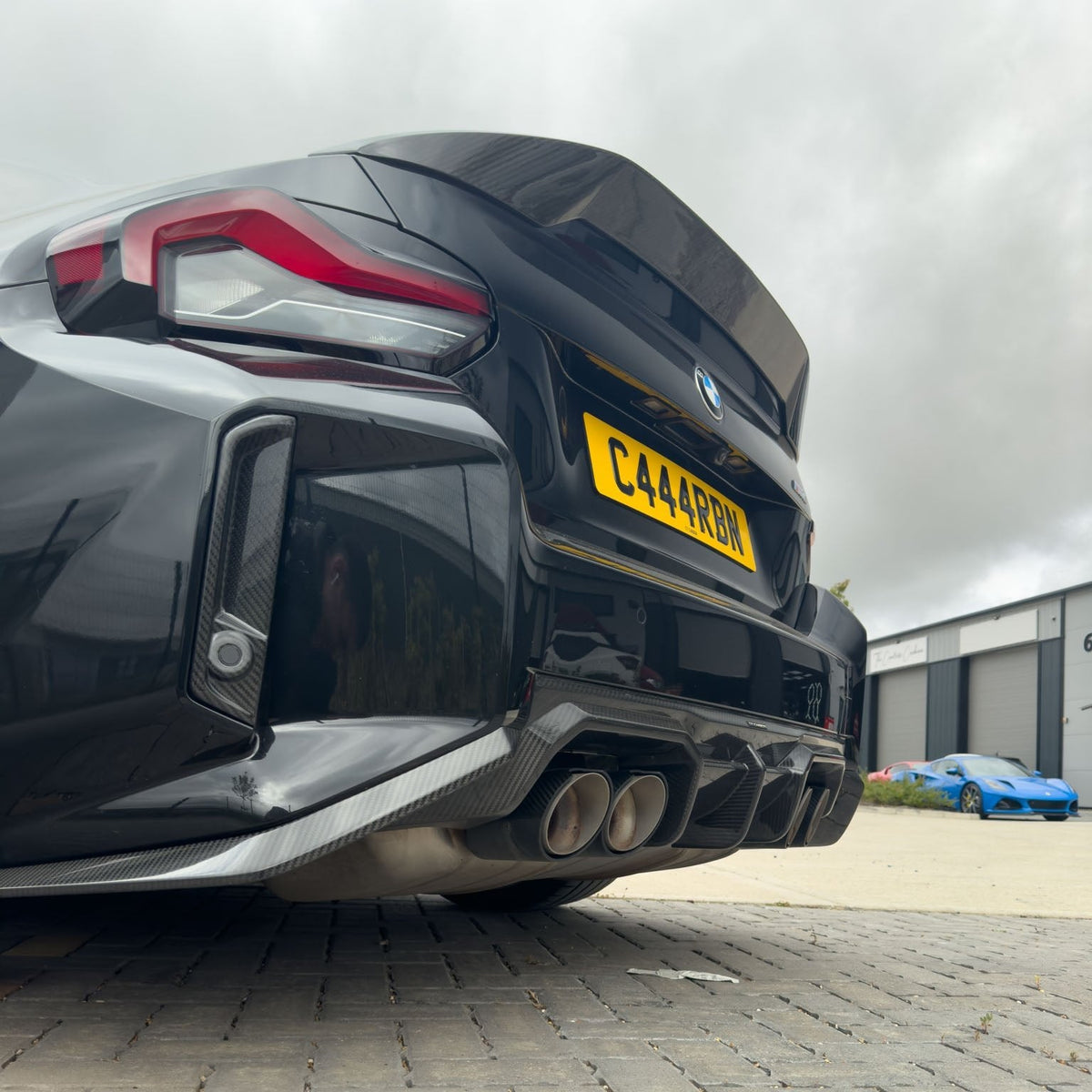 BMW G87 M2 Carbon Fibre Reflector Delete accessory by CT Carbon, showcasing sleek black carbon fibre reflector delete on the car.