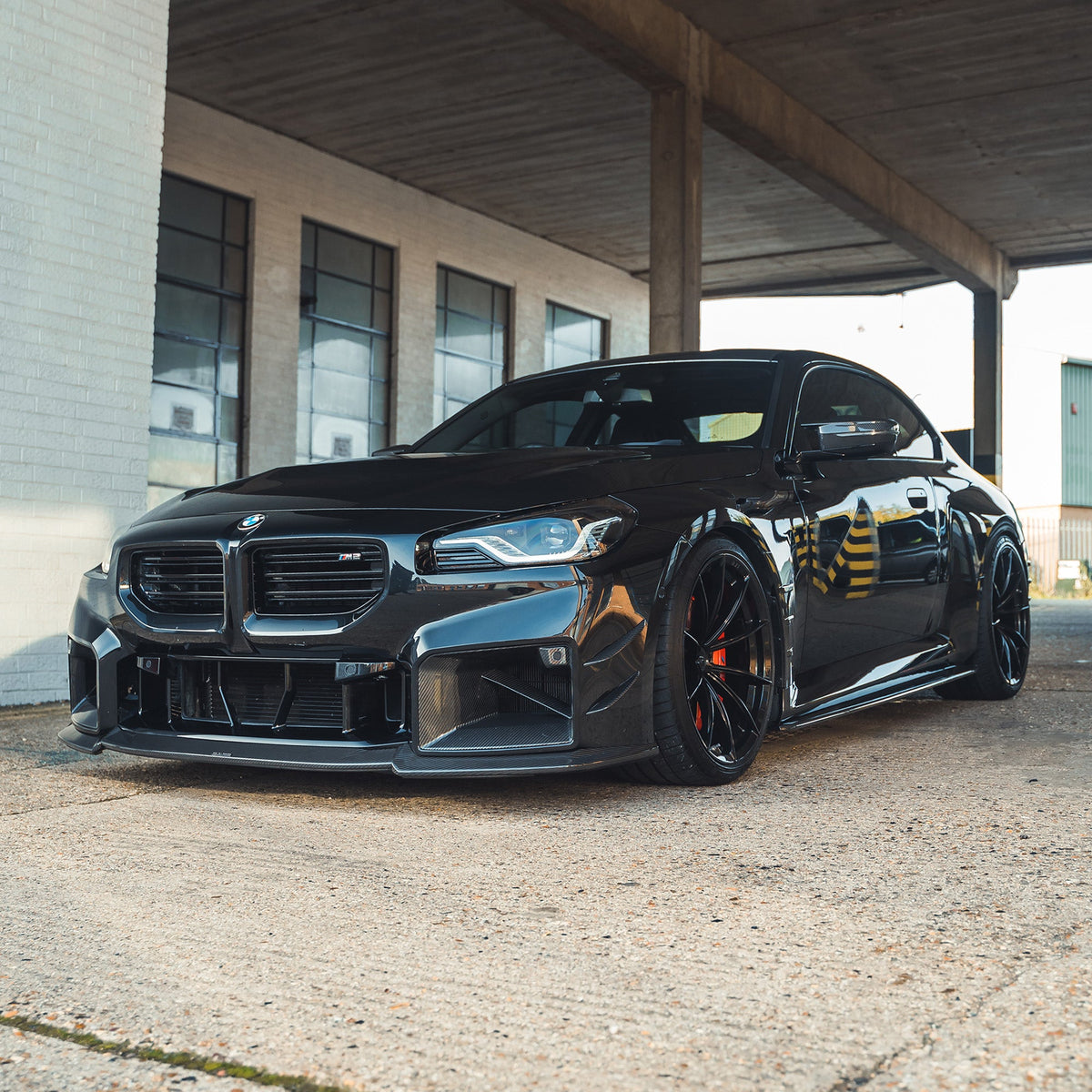 BMW G87 M2 carbon fiber splitter by CT Design, showing the sleek aerodynamic front splitter with detailed carbon fiber finish.