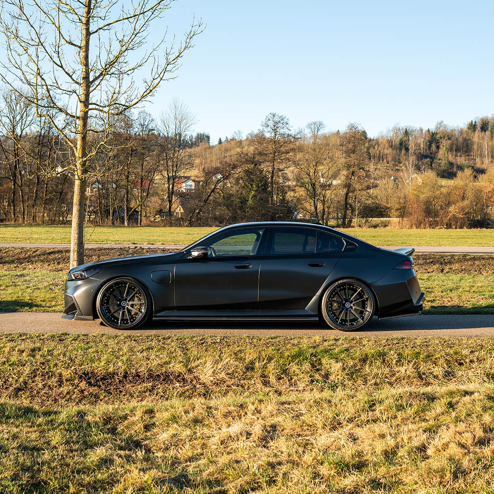 BMW G90 M5 and G99 M5 Touring 2024 carbon fibre side skirts by CT Design, showing sleek, lightweight aerodynamic enhancement.