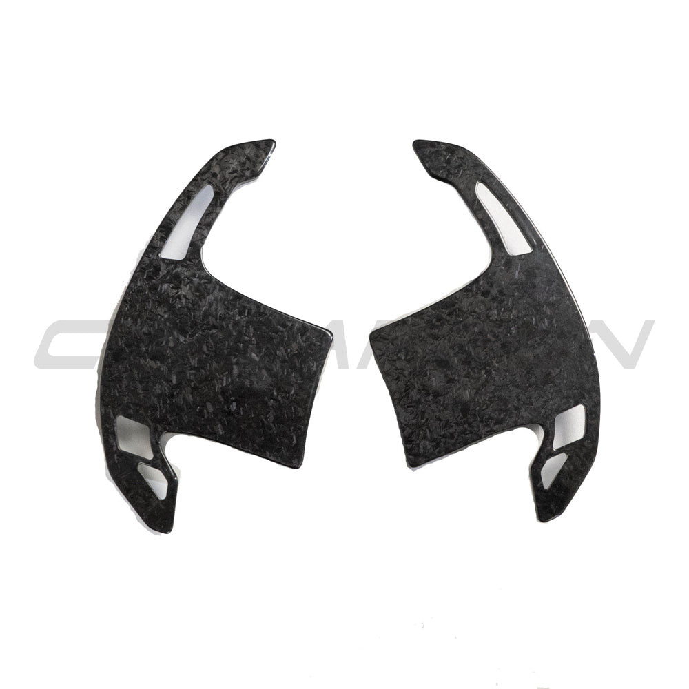 BMW Gxx forged carbon fiber shifter paddles by CT Carbon, close-up view showing the sleek, lightweight carbon fiber design.