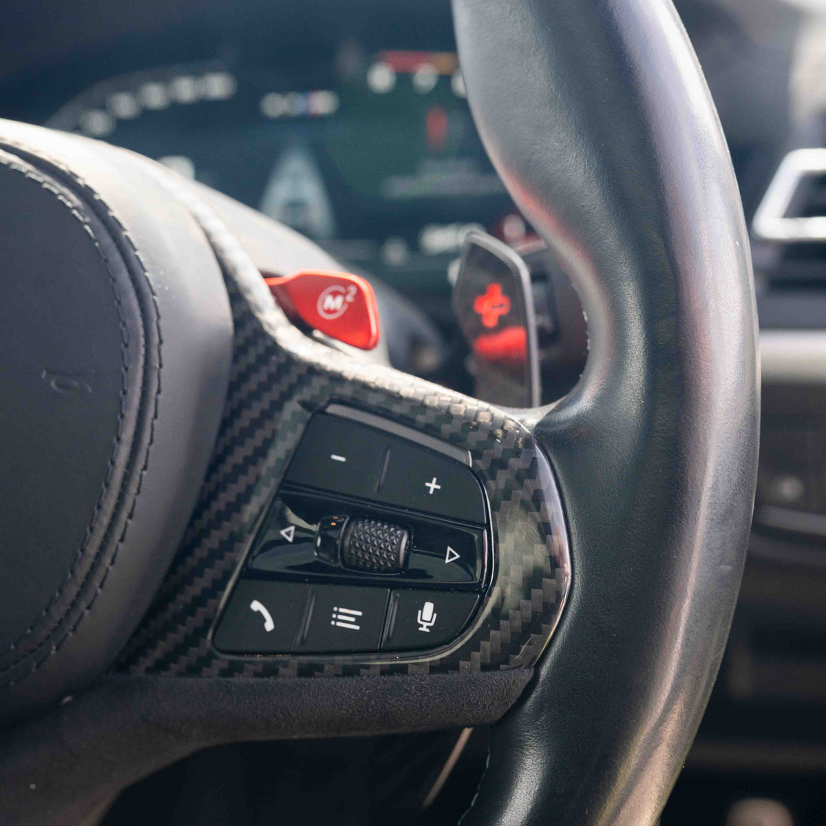 BMW Gxx M car carbon fiber steering wheel trim with heating and accessories by CT Carbon, close-up of the sleek, textured finish.