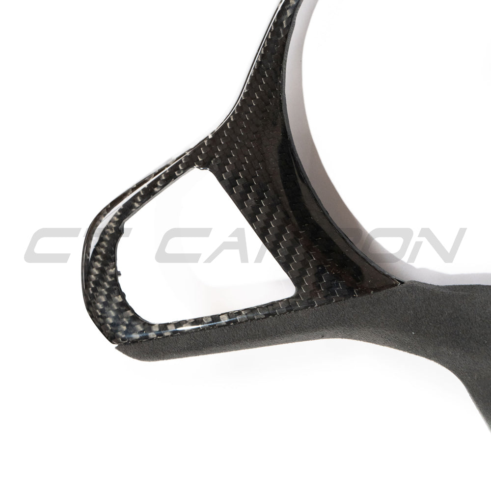 BMW Gxx M carbon fibre steering wheel trim accessory by CT Carbon with heating and accessory features, shown on a car steering wheel.