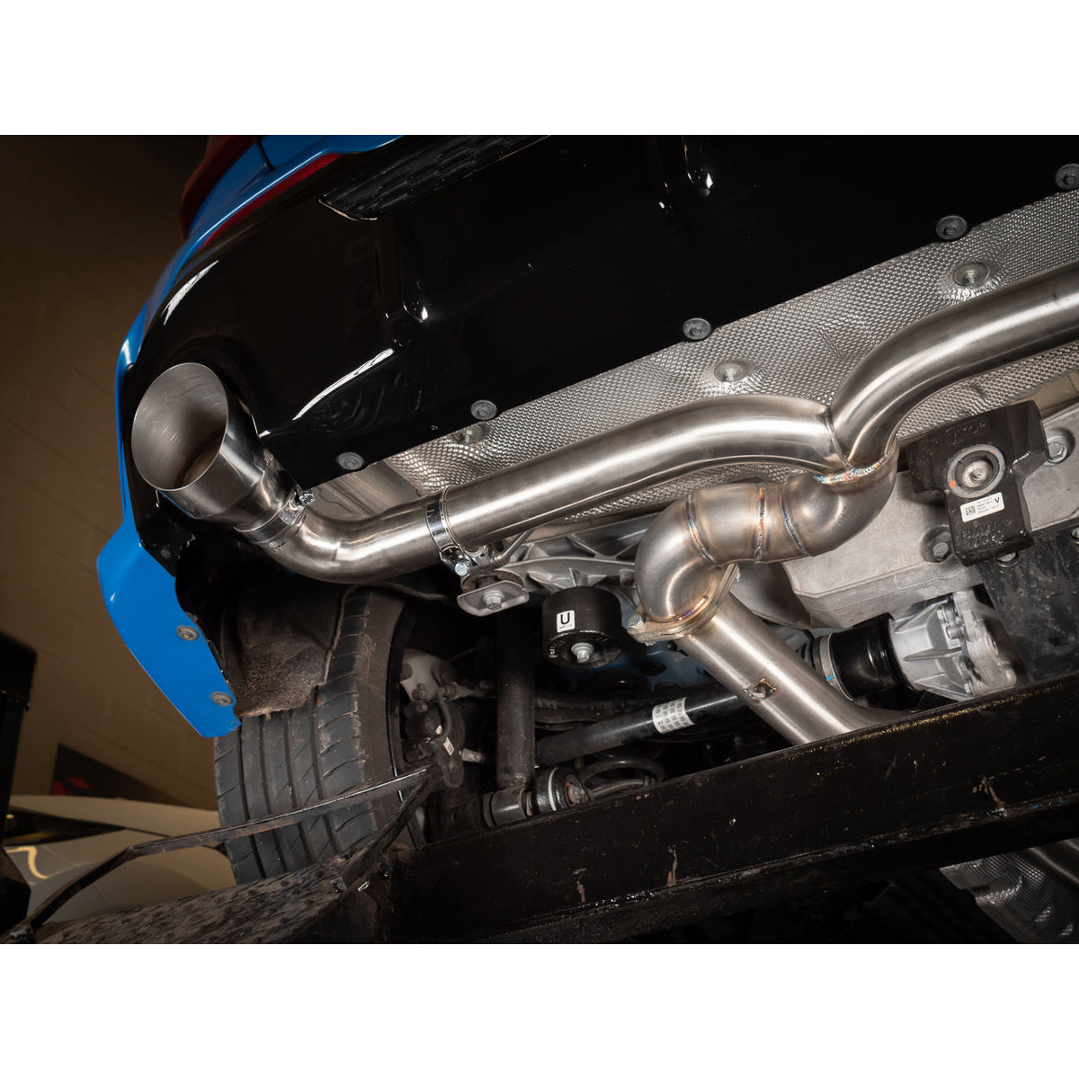 Cobra Sport BMW M135i F40 Venom Cat Back Race Box Delete Performance Exhaust showing polished metal pipes and sporty design