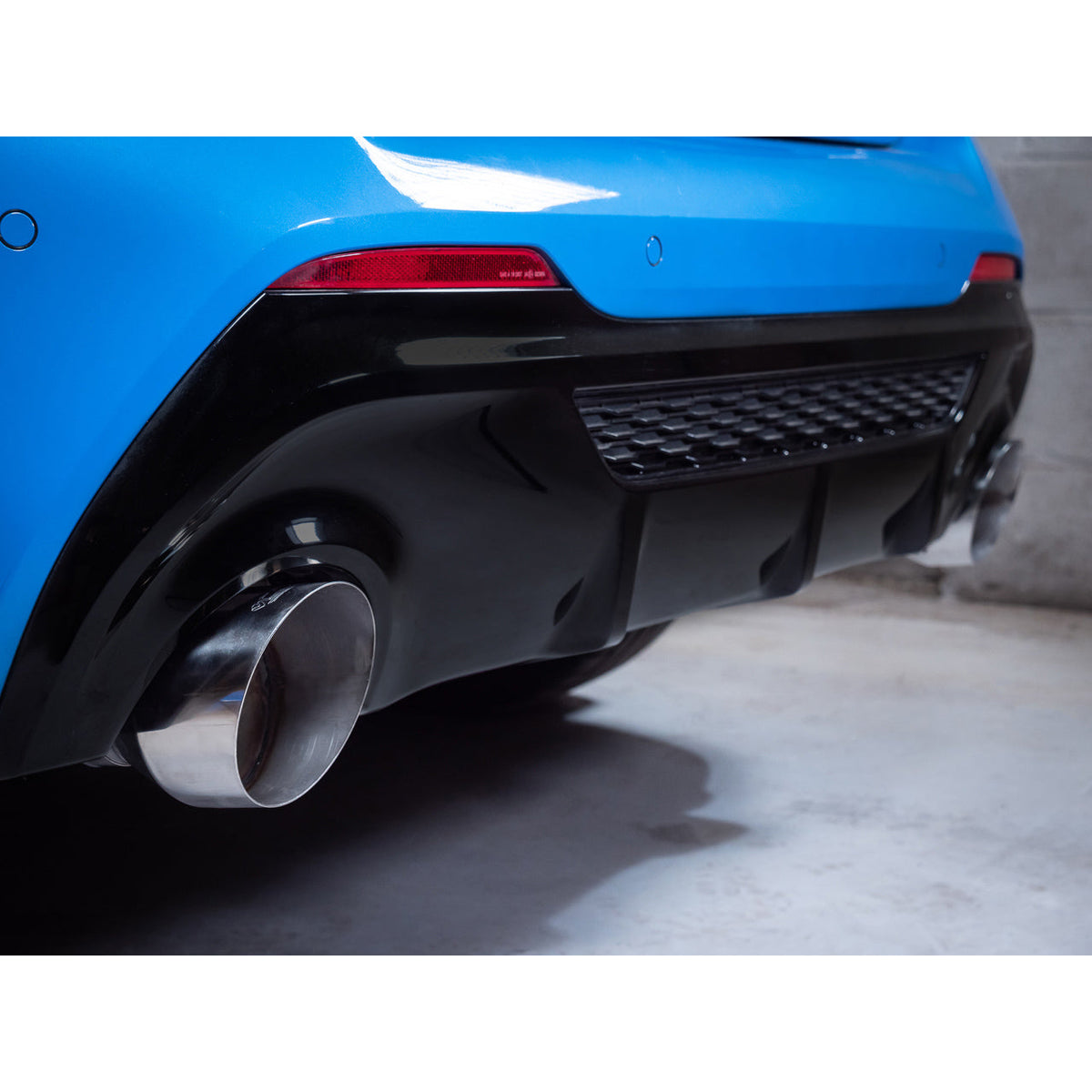 Cobra Sport cat back exhaust for BMW M135i F40 with race box delete, showcasing shiny metallic pipes and performance-focused design.