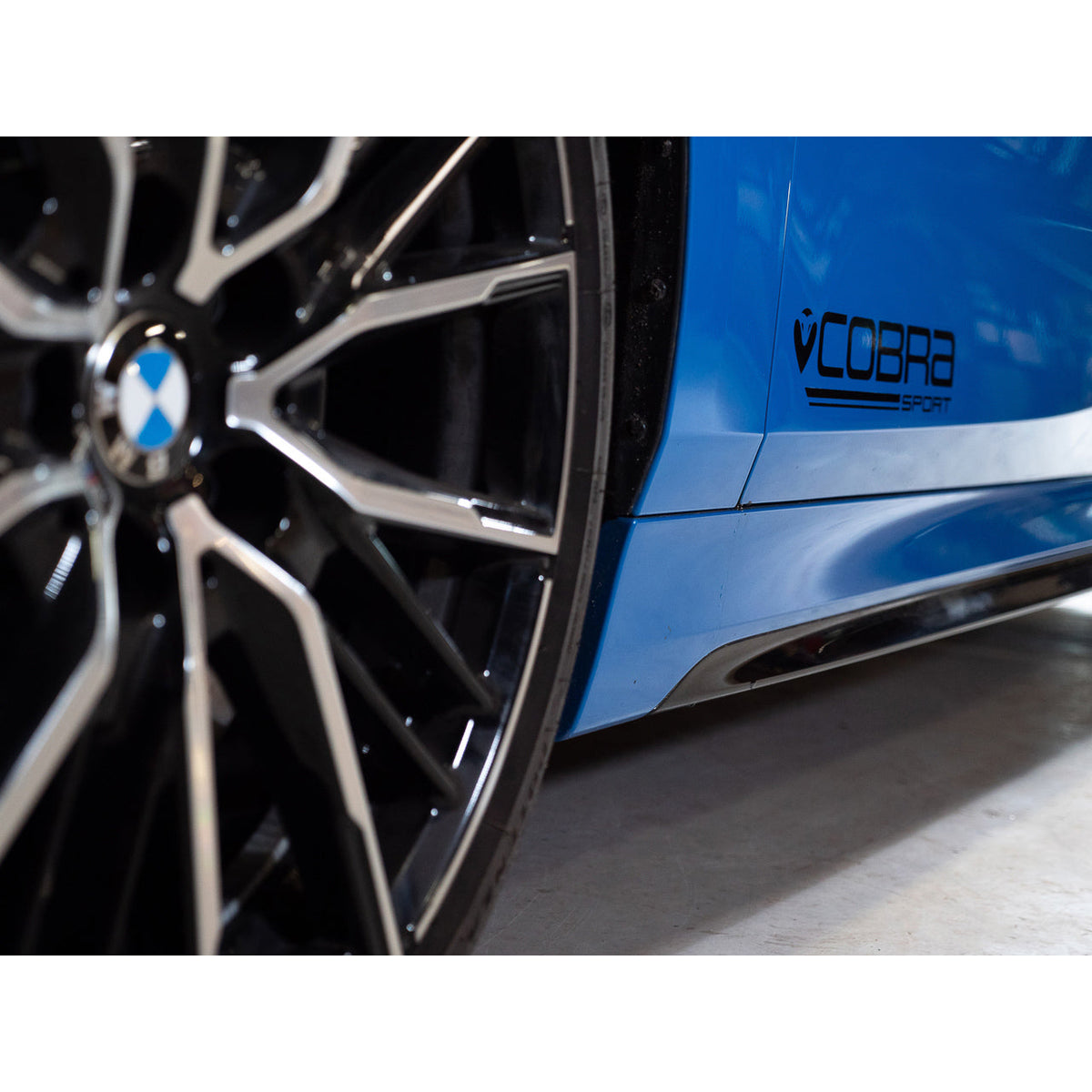 Cobra Sport BMW M135i F40 GPF/OPF delete performance exhaust, rear view showing polished metal exhaust tips and branding.