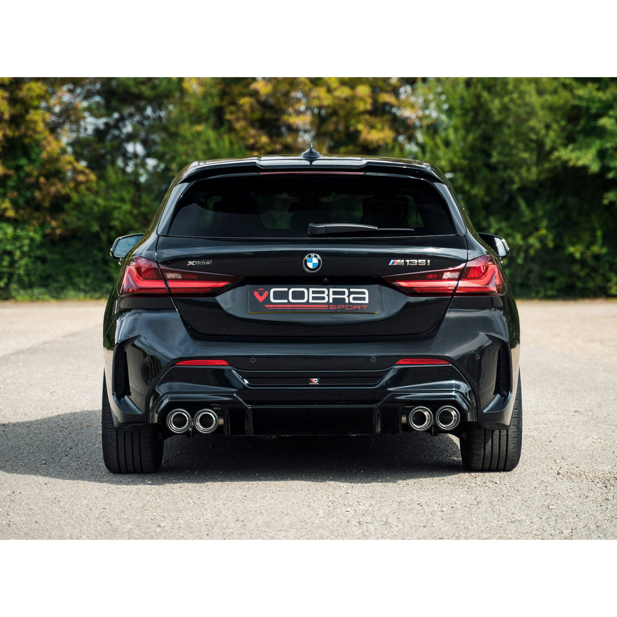 Cobra Sport BMW M135i F40 quad exit cat back performance exhaust with polished tips and dual exhaust outlets.