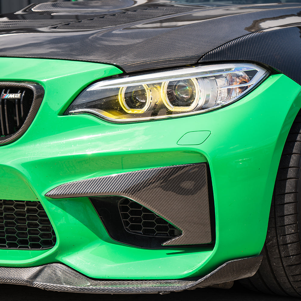 BMW M2 F87 N55 carbon fiber front bumper corners by CT Carbon, showcasing sleek, lightweight automotive accessory details.