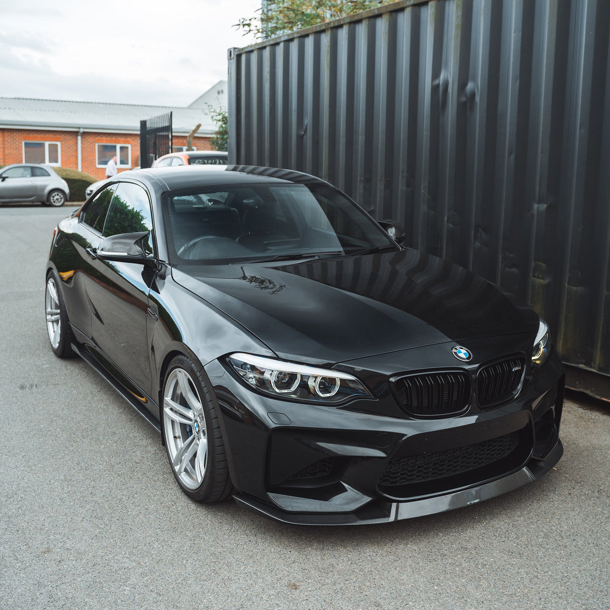 BMW M2 F87 N55 2015-2017 carbon fiber splitter by CT Carbon, featuring a sleek V2 design with a sporty M4 CS style finish.