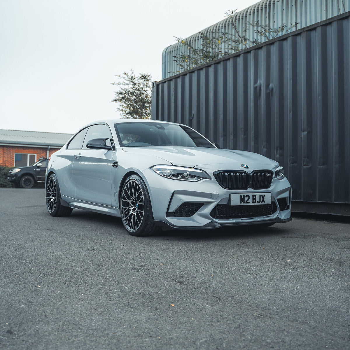 BMW M2 F87 carbon fibre side vents by CT Carbon, showcasing sleek, lightweight accessory details on the car's side panel.