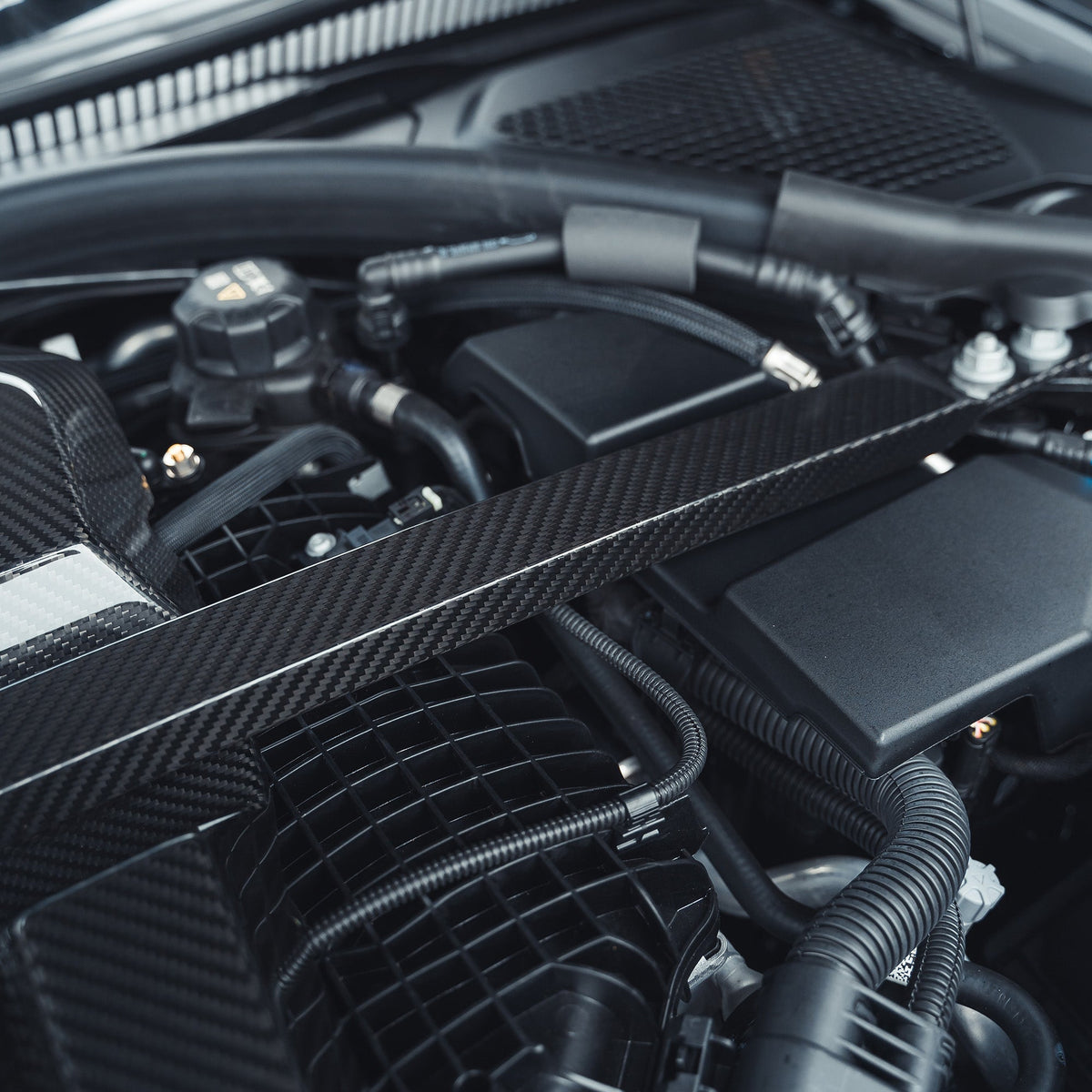 BMW M2 M3 M4 G87 G80 G81 G82 G83 carbon fibre engine dress-up kit by CT Carbon, featuring sleek, lightweight engine cover accents.