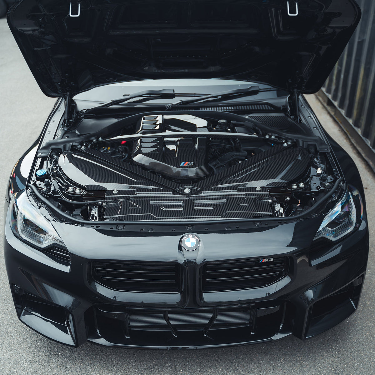 BMW M2 M3 M4 G87 G80 G81 G82 G83 carbon fiber engine strut brace by CT Carbon, showing the sleek, lightweight performance accessory.