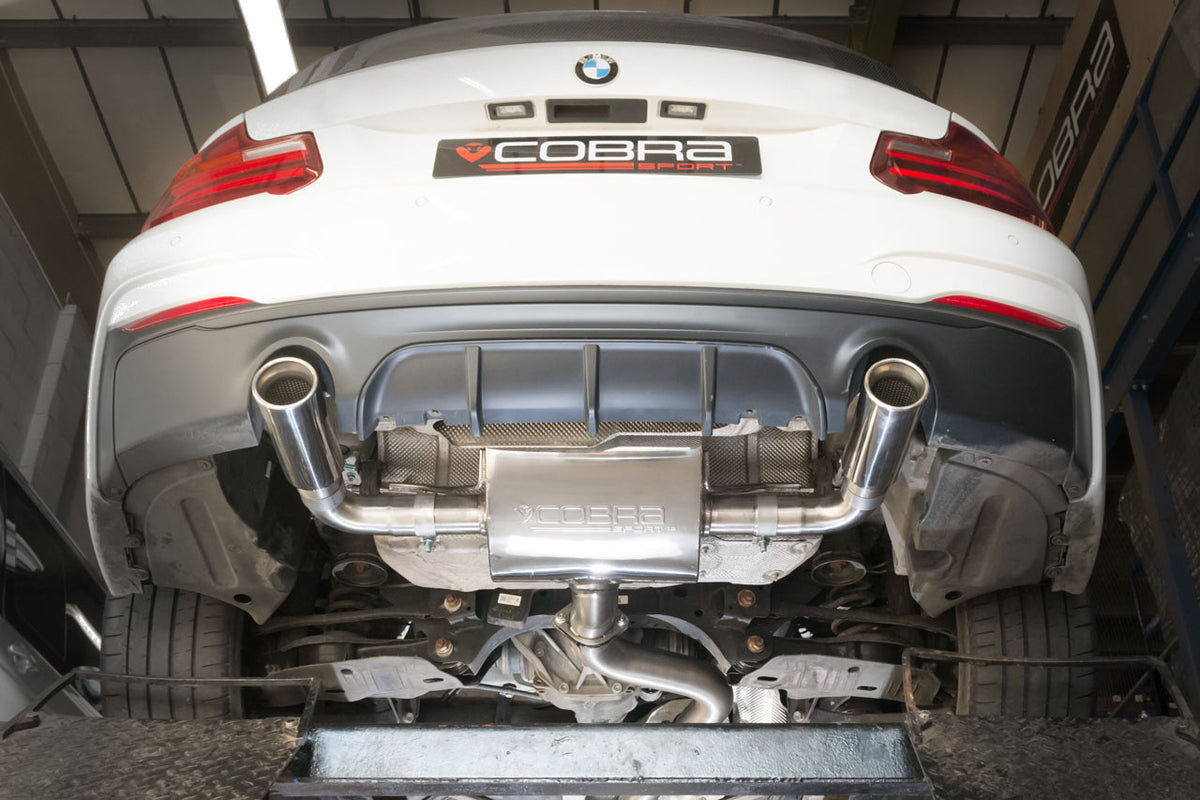 Cobra Sport BMW M240i (F22/F23) rear axle back exhaust with dual chrome tips, mounted on a black car.