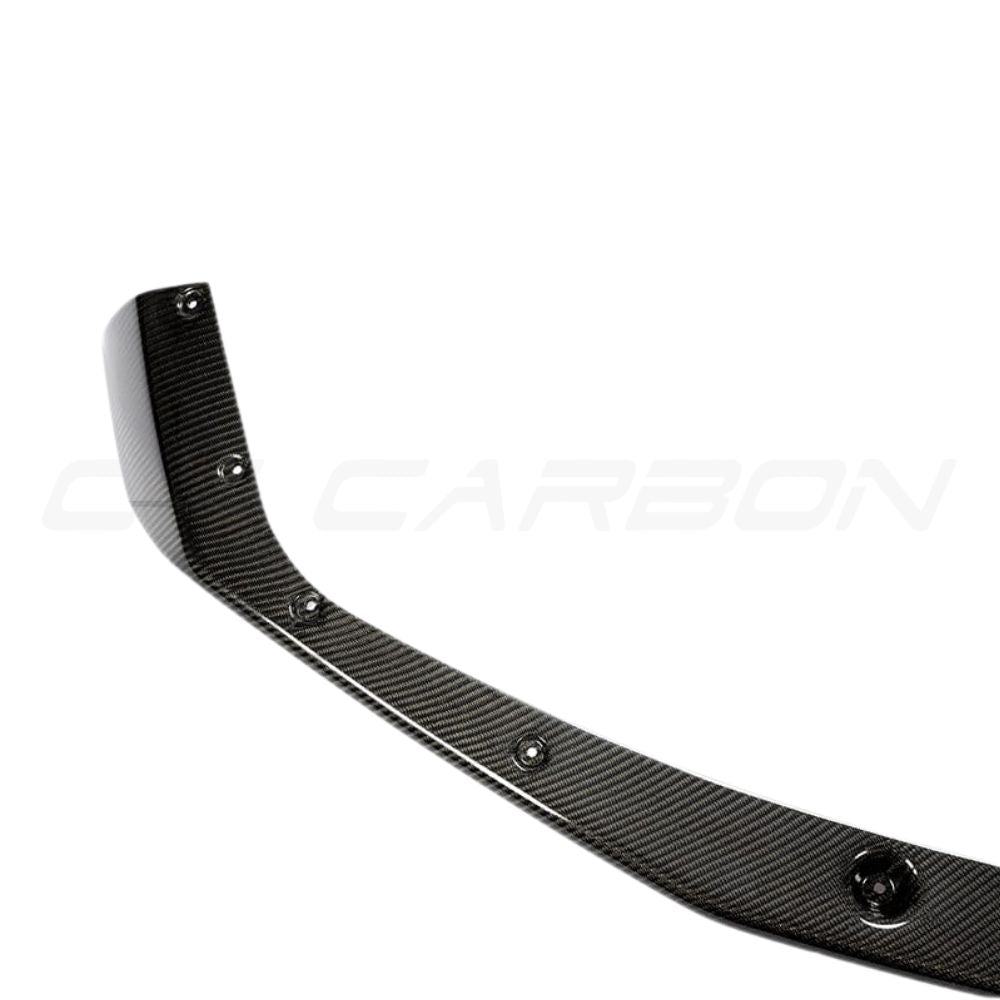 BMW M2C F87 carbon fiber splitter V3 by CT Carbon, showcasing the sleek, lightweight aerodynamic car part with detailed carbon fiber texture.