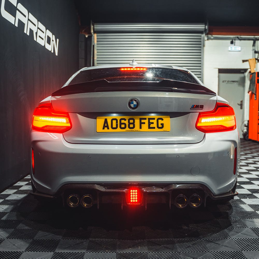 BMW M2/M2C F87 carbon fiber diffuser by CT Carbon, featuring an aggressive V6 design with sleek carbon fiber details.