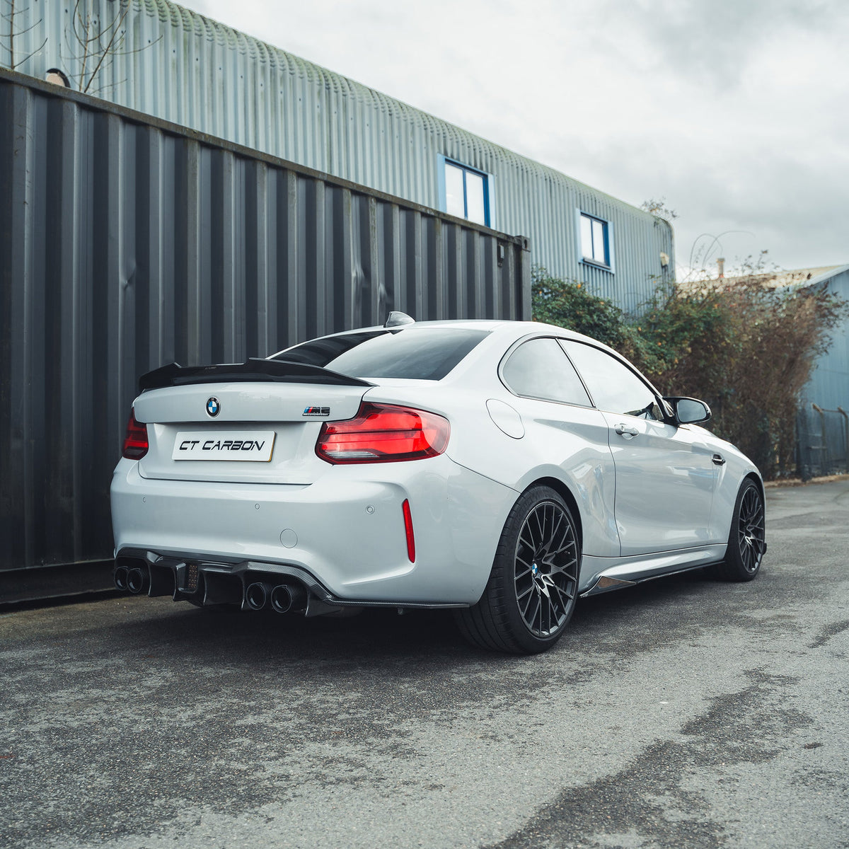 BMW M2 F87 carbon fibre diffuser by CT Carbon, featuring an aggressive V6 design, shown from the side view.