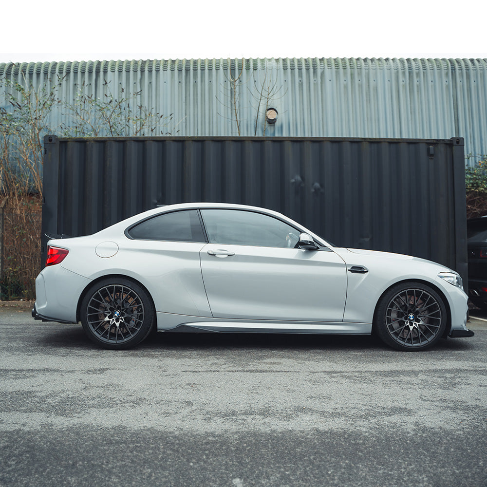 BMW M2/M2C F87 carbon fiber diffuser by CT Carbon, showcasing an aggressive V6 style design with detailed fiber pattern.