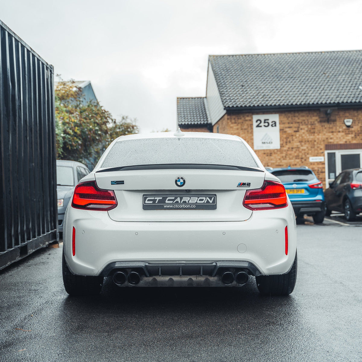 BMW M2/M2C F87 carbon fiber diffuser by CT Carbon, V2 style, featuring sleek carbon fiber finish on the rear underside.