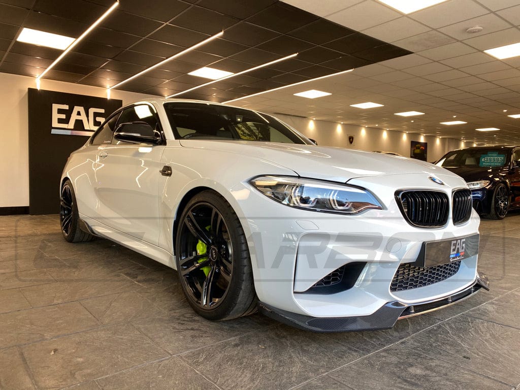 BMW M2 F87 carbon fibre side skirts by CT Carbon, V1 style, showing sleek, lightweight design and fitted installation for sporty look.