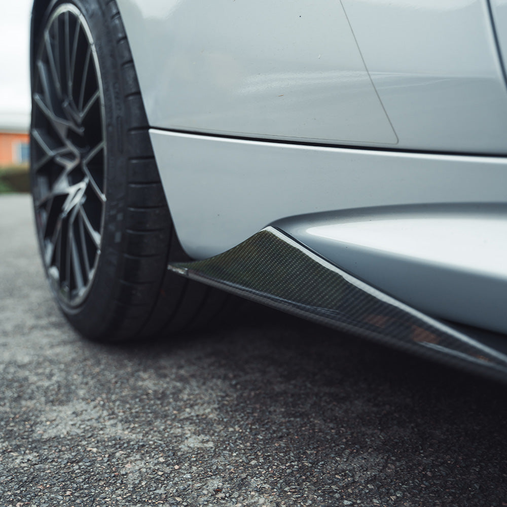 BMW M2 F87 carbon fibre side skirts by CT Carbon, V2 style, mounted on the vehicle, showcasing sleek aerodynamic design.