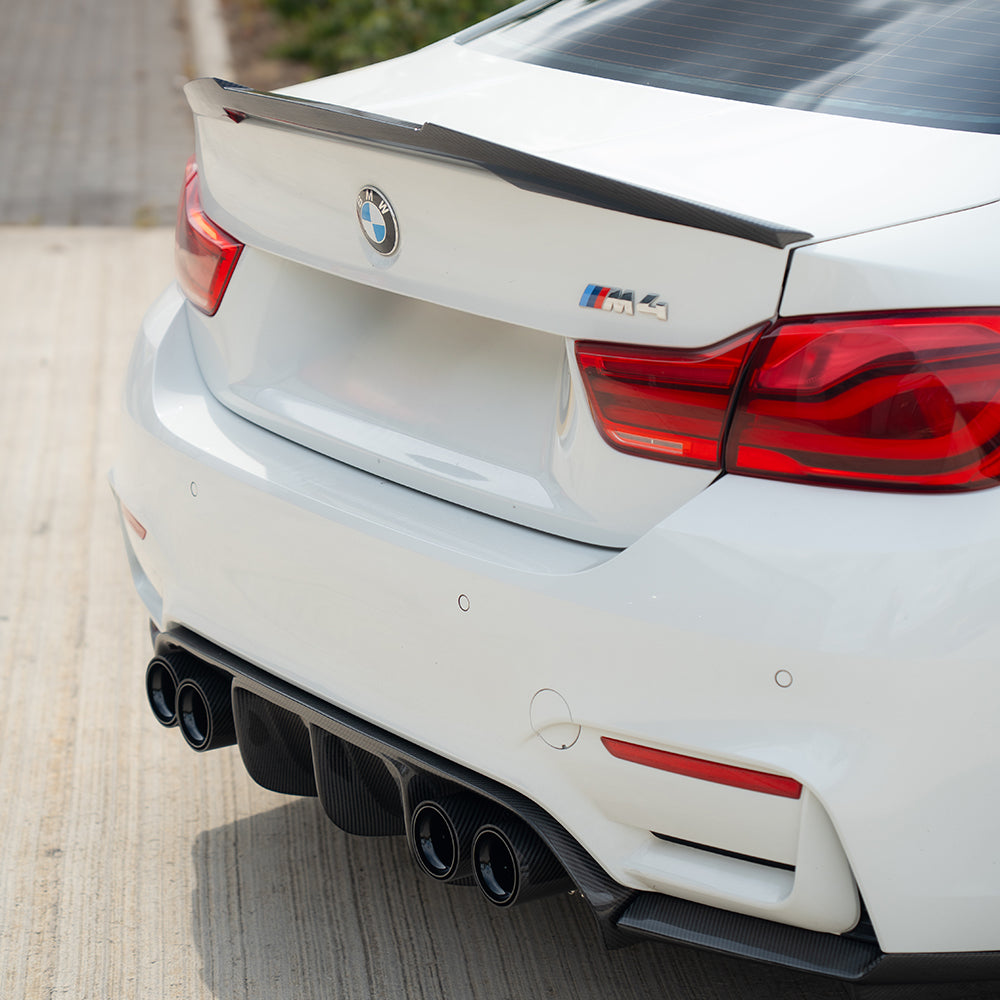BMW M3/M4 F80/F82/F83 carbon fibre diffuser by CT Carbon, showcasing sleek black exhaust tips with a lightweight, high-performance design.