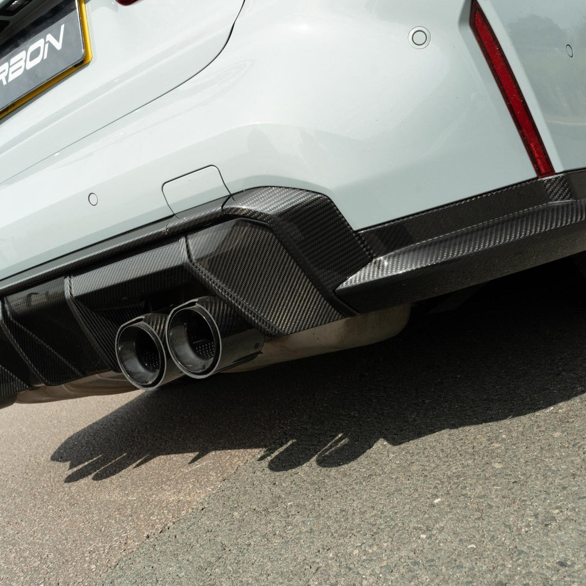 BMW M3 G80 G81 carbon fiber diffuser by CT Design, showcasing sleek black aerodynamic rear car component.