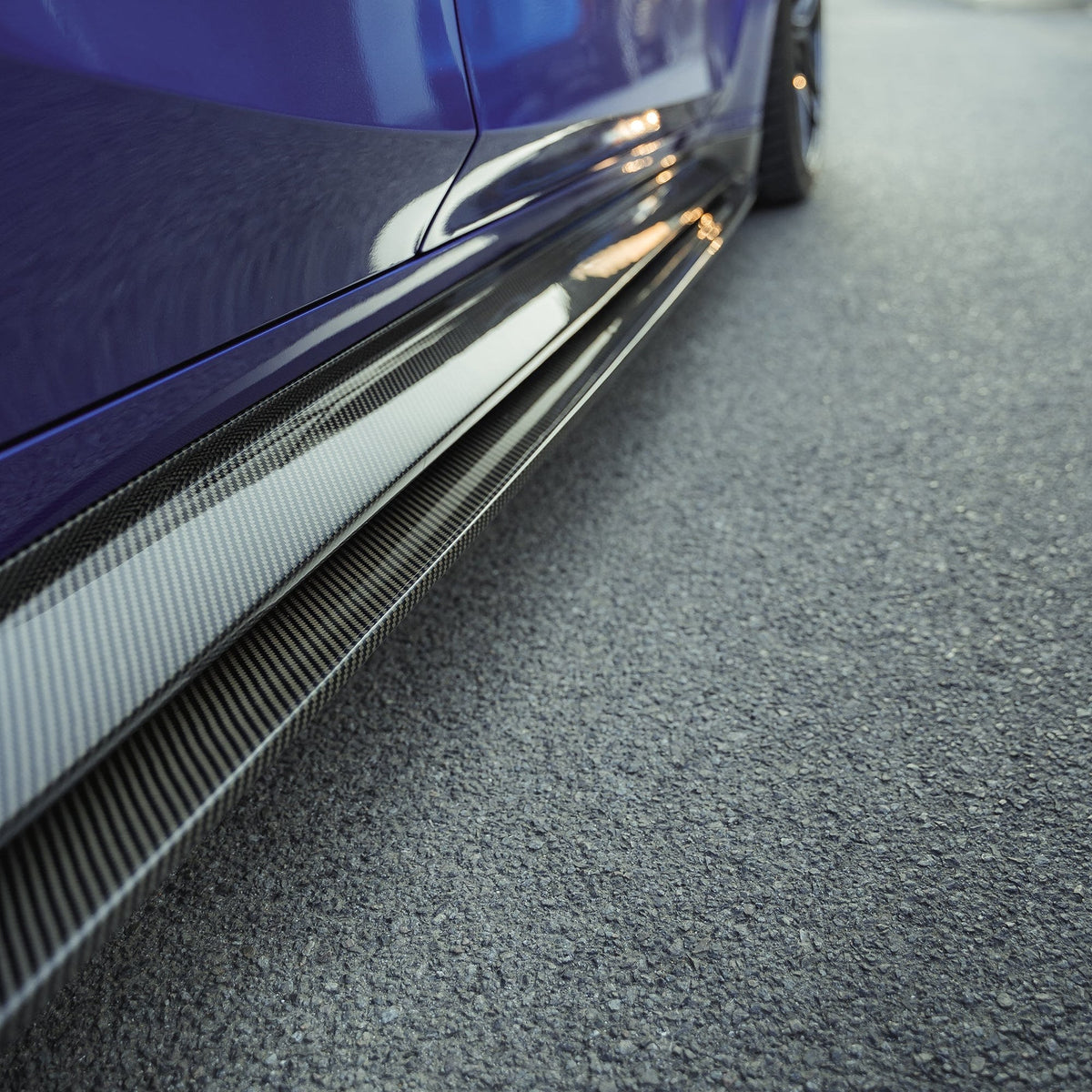 BMW M3 G80/G81 carbon fibre side skirt replacement and extension by CT Carbon, showcasing sleek, lightweight side skirt design.