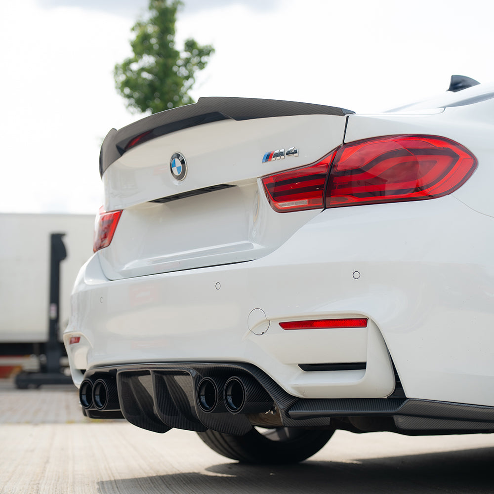 BMW M3 M4 F80 F82 F83 carbon fiber diffuser by CT Carbon, V2 style, showing the sleek, textured carbon fiber finish.