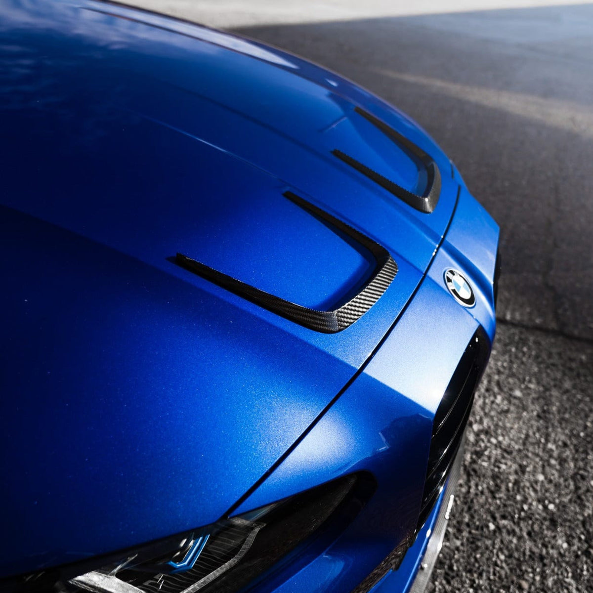 BMW M3 M4 (G80 G81 G82 G83) carbon fibre bonnet hood trims by CT Carbon, close-up of sleek, lightweight automotive accessories.