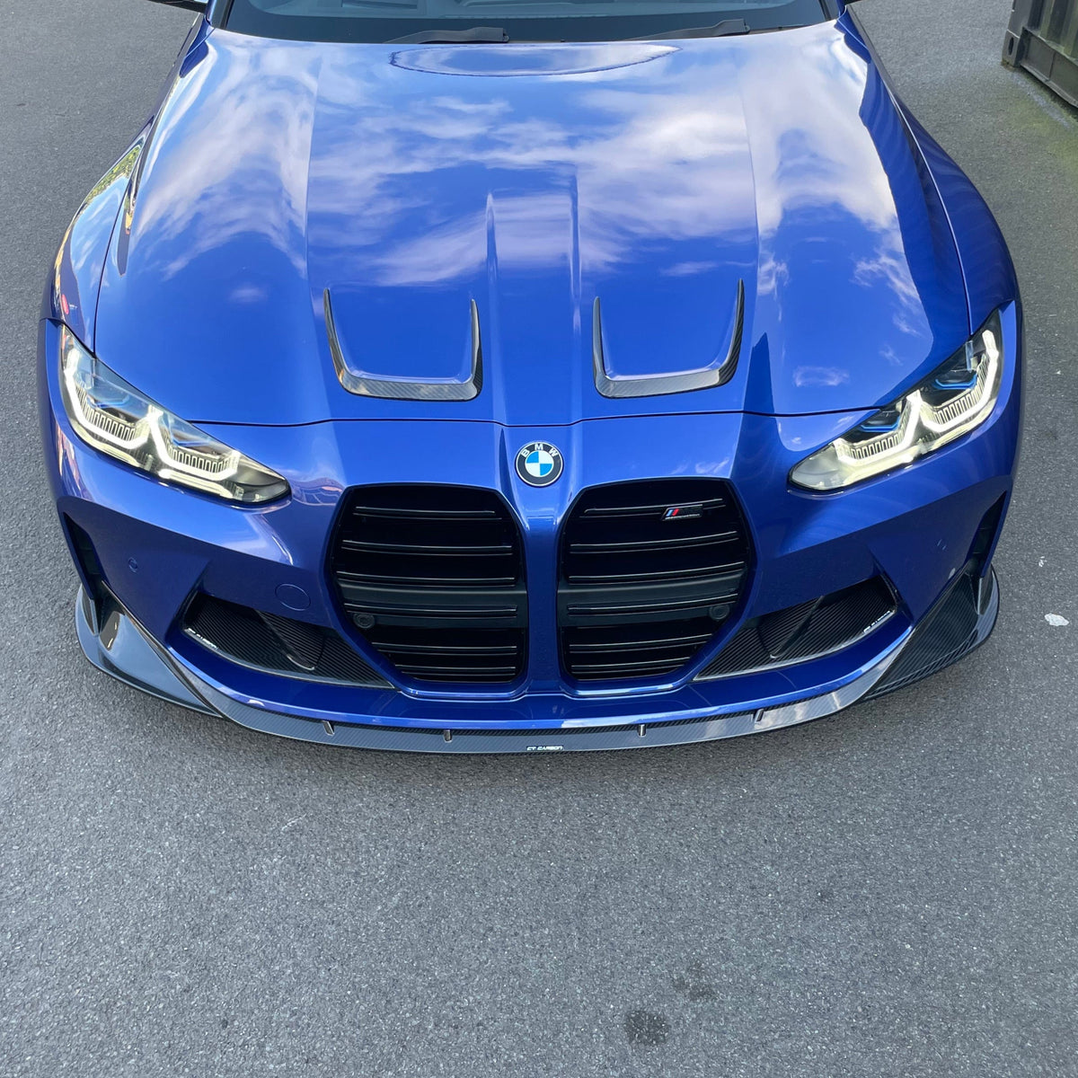 BMW M3 M4 G80 G81 G82 G83 carbon fiber bonnet hood trims by CT Carbon, close-up view showing sleek, lightweight automotive accessories.